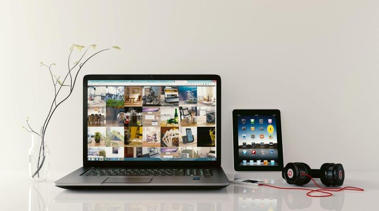 laptop-en mode plein écran (avec un casque et smartphone sur le côté)